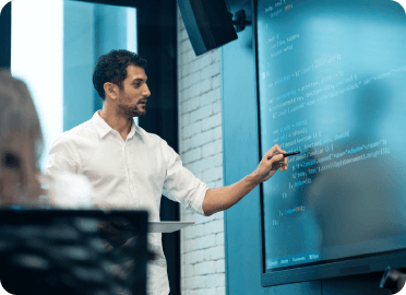 Man presenting in front of a digital screen